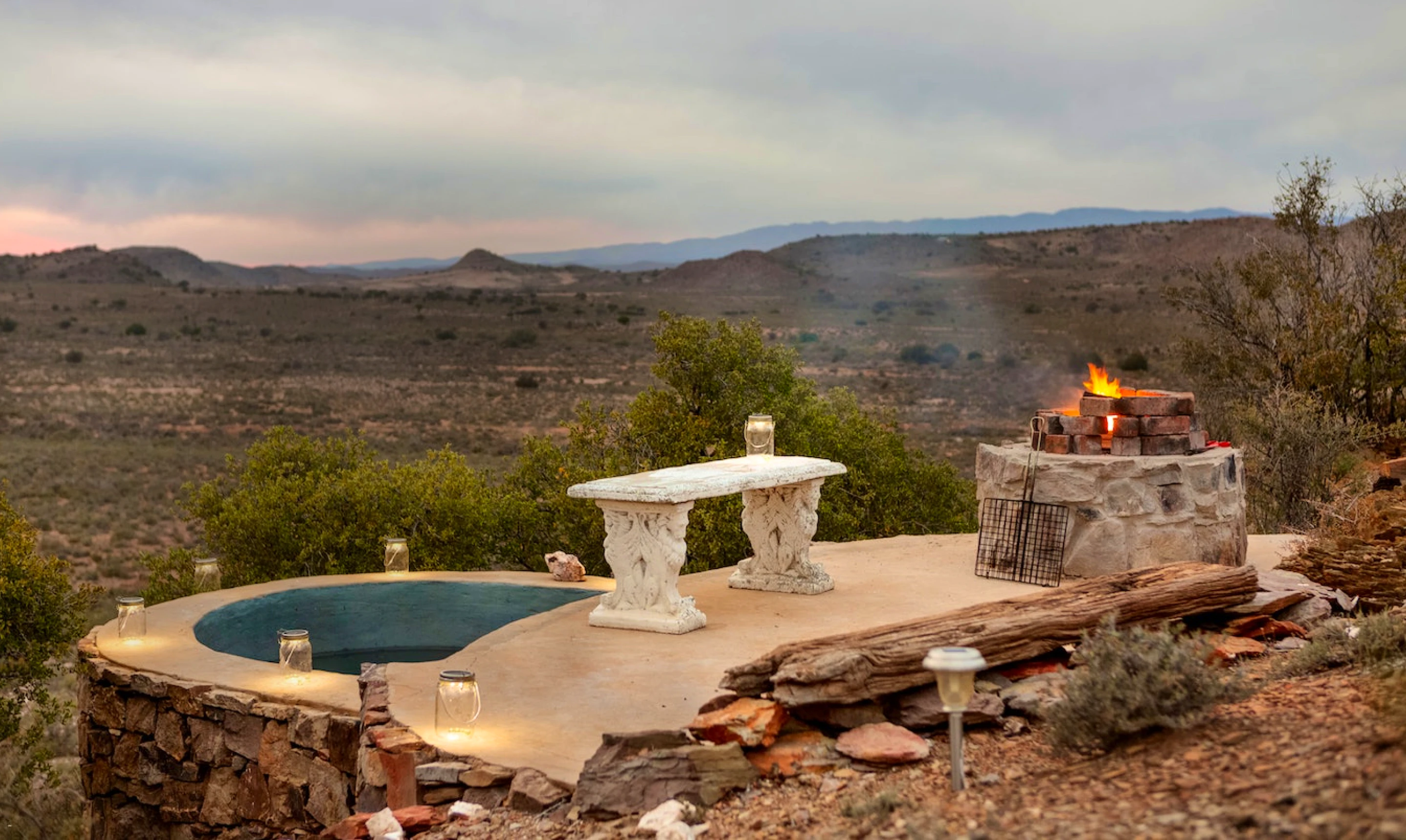 A braai pit and jacuzzi overlooking the Karoo landscape